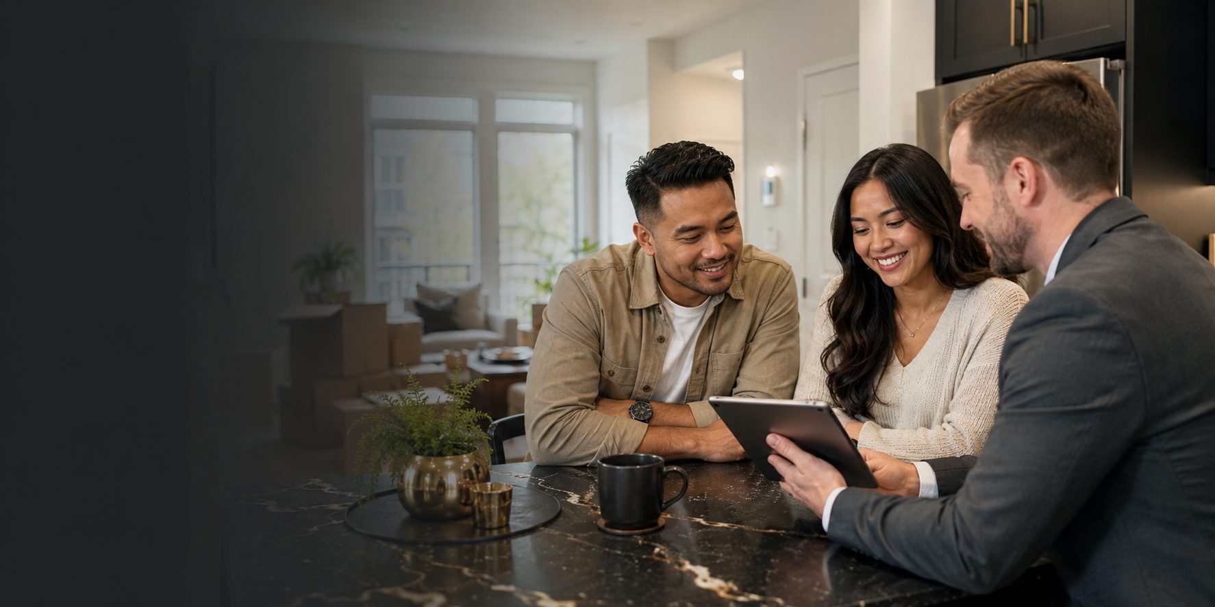 A couple reviewing home financing options with an advisor at a kitchen island
